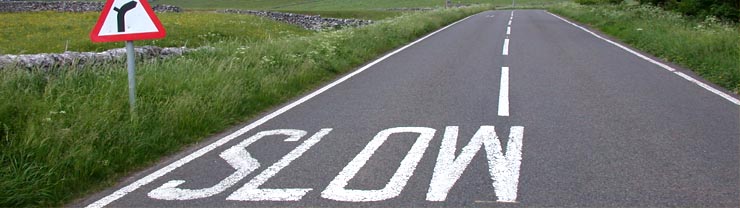 Road with painted slow sign